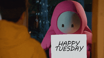 Video game gif. A character from Fall Guys is parodying a scene from Love, Actually and stands in the doorway of someone's house with a sign that reads, "Happy Tuesday."