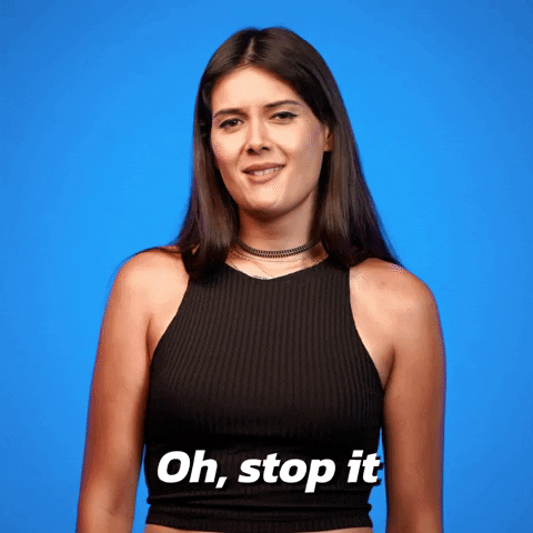Video gif. A woman moves back and forth shyly as she says, "Oh, stop it."