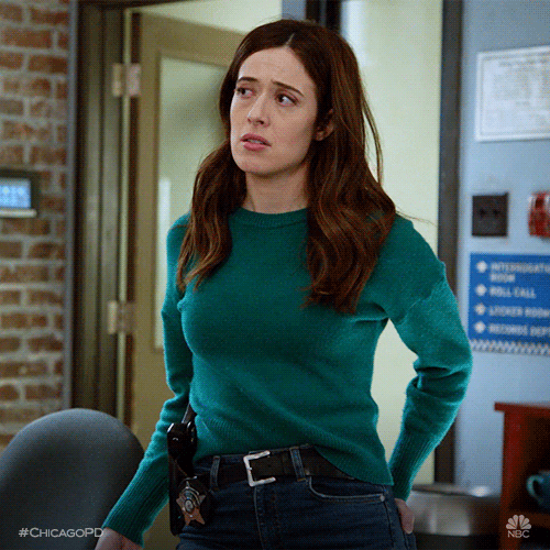 TV gif. Marina Squerciati as Kim in Chicago PD. She has a hand in her back pocket as she shrugs and looks around, thinking that it's not a bad suggestion.