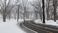 Jogger Runs Through Snow Flurries at Jersey City's Lincoln Park