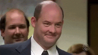 The Office gif. David Koechner as Packer nods knowingly towards Steve Carell as Michael, who breaks into a smile and says, “That’s what she said.” An exasperated Melora Hardin as Jan puts her hand to her forehead and says, “oh my god.”