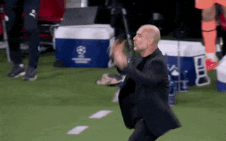 Sports gif. Pep Guardiola stands on the sidelines of a soccer game, clutching his head, running backwards, then holding out his hands in disbelief. 