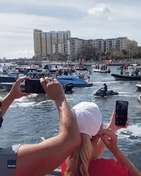 Super Bowl MVP Tom Brady Tosses the Lombardi Trophy During Tampa Boat Parade