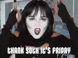 Video gif. In an office setting, we see a young woman with black hair, black lipstick, and white face makeup wearing black clothes with metal accessories. She shouts at us while making backwards metal horns: Text, "Thank goth it's Friday. Yeah!"