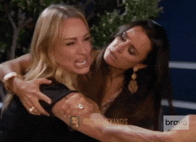 Reality TV gif. Taylor Armstrong from The Real Housewives of Beverly Hills is screaming, crying, yelling and pointing. The camera pans to who she's pointing at and it's a white cat who meows.