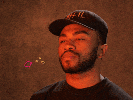 Celebrity gif. Kevin Abstract of Brockhampton does a chef's kiss, touching his fingers to his lips and pulling them away, as animated confetti appears.
