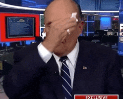 TV gif. Rudy Giuliani making an appearance on Fox News wiping his forehead, mouth, and eyes with a white cloth.