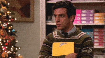 The Office gif. BJ Novak as Ryan holds a folder as he nods his head, then makes eye contact with us and points offscreen.