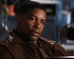 Movie gif. Denzel Washington places his palms over his heart, then leans back, shakes his head, and smiles.