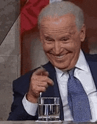 Political gif. Joe Biden points at us with a pen in his hand and an exaggerated smile on his face before he lowers his hand and his expression turns disappointed.
