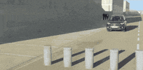 Ad gif. Gray Honda CR-V appears to drive over three cement pillar barriers, then the image stretches and appears to reverse.