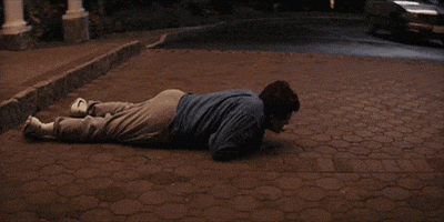 Movie gif. Leonardo DiCaprio as Jordan on Wolf of Wall Street. He's incredibly drunk and incapable of walking, so he crawls over to his car and tries to get in, but fails.