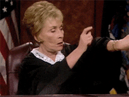 Judge Judy tapping her desk and watch to tell them to