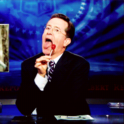 TV gif. Stephen Colbert on The Colbert Report licks a lollipop in an over-the-top seductive manner.  