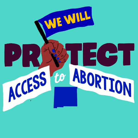 Text gif. Brown hand with blue fingernails in front of mint green background waves a blue flag up and down that reads, “We will,” followed by the text, “Protect access to abortion. New Mexico.”