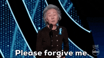 Celebrity gif. Young Yuh Jung at the Academy Awards stands in front of a microphone, looking around earnestly as she says, “Please forgive me.”