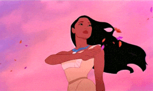 Disney gif. With the wind in her hair, Pocahontas waves goodbye as colorful leaves fly past her.