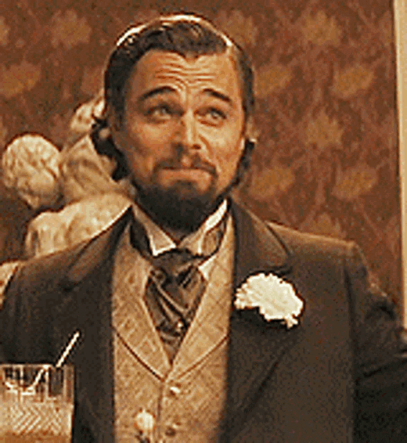 Movie gif. Leonardo DiCaprio as Calvin in Django Unchained raises his eyebrows and smirks as if slightly impressed.  