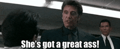 Movie gif. Al Pacino as Lieutenant Vincent Hanna in Heat, eyes wide with drama, using his hands to illustrate a woman's curves, shouts "she's got a great ass!"