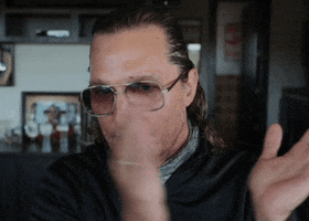 TV gif. Matthew McConaughey on the Tonight Show grins as he claps with intensity. 