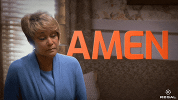 Movie gif. A woman bows her head and lifts a hand as she says, "Amen."