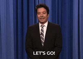 Tonight Show gif. Jimmy Fallon as host whirls his hand in front of himself as he nods and says, "Let's go!"