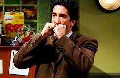 Friends gif. David Schwimmer as Ross balls his fists up near his face, trembling in anxiety before pressing his fingertips onto his face. 