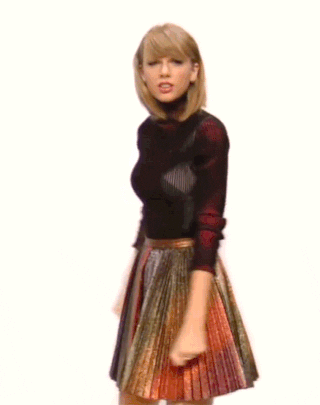 Celebrity gif. Taylor Swift karate chops both hands to her thigh as if to gesture, "Suck it."