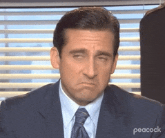 The Office gif. Steve Carell as Michael looks up with sad eyes and a big frown on his face, disappointedly shaking his head.