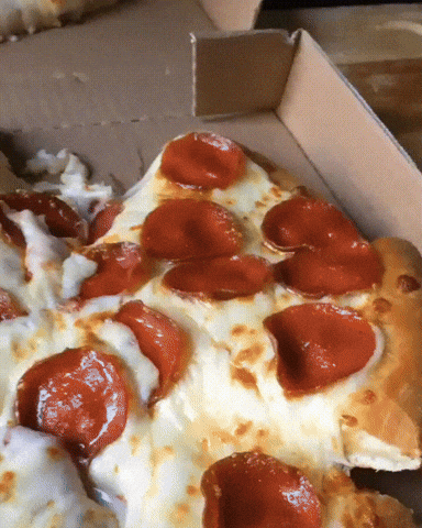 Video gif. A slice of pepperoni pizza being taken out of the box but the cheese pull is so thick and scrumptious. They slowly lift the slice higher and higher and the cheese never breaks, only stretches deliciously. A second shot of a second slice displaying the same deliciousness. 