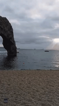 World Record Holder Uses Jetpack to Swoop Through Sea Arch