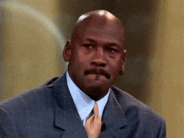 Celebrity gif. Michael Jordan bites his lip, then scrunches up his face in laughter, covers his mouth, and cracks up before catching his breath.