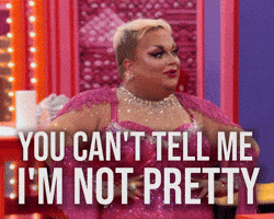 Reality TV gif. A Drag Queen on Rupaul’s Drag Race stands with their hands on their hips in a bedazzled bodysuit and glam makeup painted on their face. They say, “You can't tell me I'm not pretty,” and they look around the room confidently. 