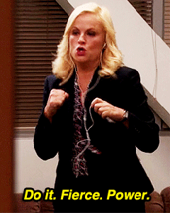 Parks and Recreation gif. Amy Poehler as Leslie wears headphones as she throws an air punch. Text, "Do it. Fierce. Power."
