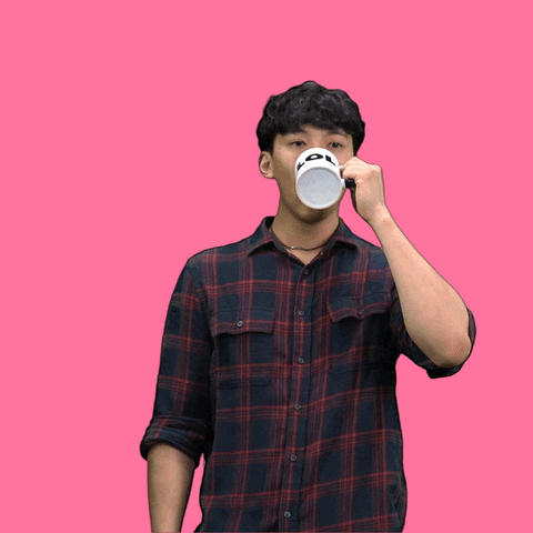 Video gif. Man does a spit take in front of a bubble gum pink background. He takes a sip from a mug, then grasps his stomach, leans forward, and spews cartoon liquid from his mouth.
