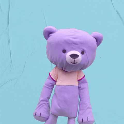 Video gif. Teddy Too-Big, a purple mascot bear, does a two-step dance. Text, "Going up on a Tuesday."