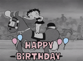 Cartoon gif. Betty Boop is standing on a horse that rides by and she blows kisses to the crowd. Text, "Happy Birthday!"