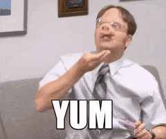 The Office gif. Rainn Wilson as Dwight sits on a couch with a pig snout on his face. He over exaggeratedly stuffed imaginary food into his mouth, almost in a mocking manner as he bounces up and down with each big bite. Text says, ‘Yum”