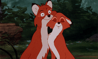 Cartoon gif. Vixey from The Fox and the Hound nuzzles up close, under Tod’s head. Tod practically melts.