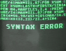 Video gif. Neon green code text on computer screen precedes a blinking phrase, "Syntax error," which is then followed by a scene of a woman swinging a sledgehammer at a computer, causing it to explode.