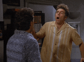 Seinfeld gif. Michael Richards as Kramer exclaims and jerks, turning around and looking back in disbelief.