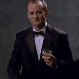 Celebrity gif. Bill Murray holds a glass of alcohol in his hand and points at us while lifting his eyebrow up. Text, “Happy Birthday to you!”