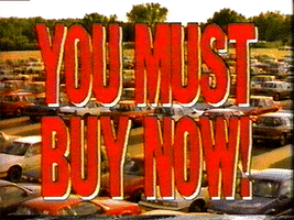 TV gif. We zoom out on a large lot full of cars. Red flashing text fills the frame, "You must buy now!"