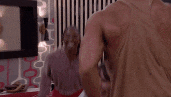Reality TV gif. Group of five or six participants from Big Brother season 24 jump and dance and pump their arms excitedly in a living room.