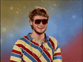 Celebrity gif. Bobbing and smiling, Rapper Yung Gravy nods his head and points both of his hands at us.