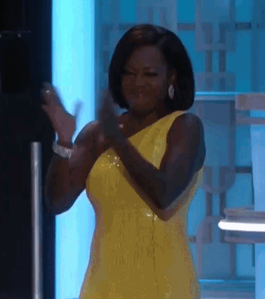 Celebrity gif. Viola Davis wears a yellow gown at the Golden Globes as she claps forcefully.