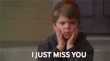 Movie gif. Travis Tedford as Spanky from Little Rascals sits, looking sad, resting his face in both hands. Text. "I just miss you."