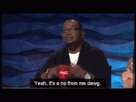 TV gif. American Idol Judge Randy Jackson leans on the judge’s desk looking up at the stage. He flops his arms down on the table and gives a sorry shake of his head, saying, “Yeah, it’s a no from me dawg.” 