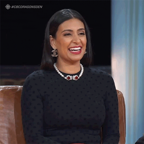 Celebrity gif. A slightly embarrassed Manjit Minhas giggles and brings her hand to her forehead as if to say, “Oh no.”
