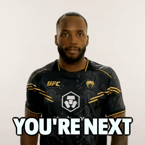 Video gif. UFC fighter Leon Edwards holds his arm straight out to point at us with a serious expression. Text, "You're next."
